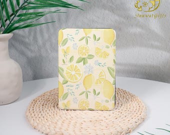 May include: A yellow and white notebook cover with a lemon print. The cover is on a woven straw mat.
