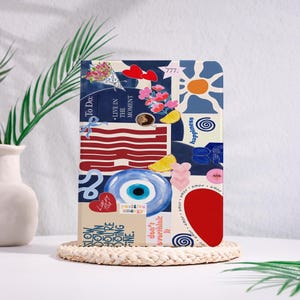 May include: A rectangular tablet case featuring a collage of colorful illustrations including a blue evil eye, red hearts, a bouquet of flowers, a coffee cup, lemon slices, and text that reads To Do, Live in the Moment, and Positive Energy.