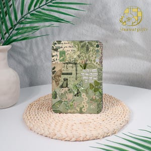 May include: A rectangular, green and beige decorative box with a collage design featuring butterflies, flowers, and text. The box has a vintage aesthetic, with a quote that reads "and if I could give you the moon I would give you the moon."
