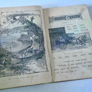 May include: Open vintage book with illustrations. One page shows a lake scene with figures and swans. The opposite page has text and a horse-drawn carriage illustration. The book is titled "Second Reader."