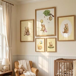 May include: A set of framed nursery art prints with watercolour illustrations of a bear. The artwork includes images of the bear with honey, a balloon, and flowers, set against a yellow and white background.