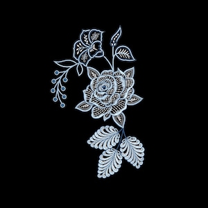 May include: An intricate floral design featuring a rose and other flowers with leaves and berries, rendered in shades of white and blue against a black background. The design has a detailed, embroidered appearance, suggesting a textile or digital art piece.