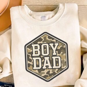 a t - shirt with the words boy dad printed on it