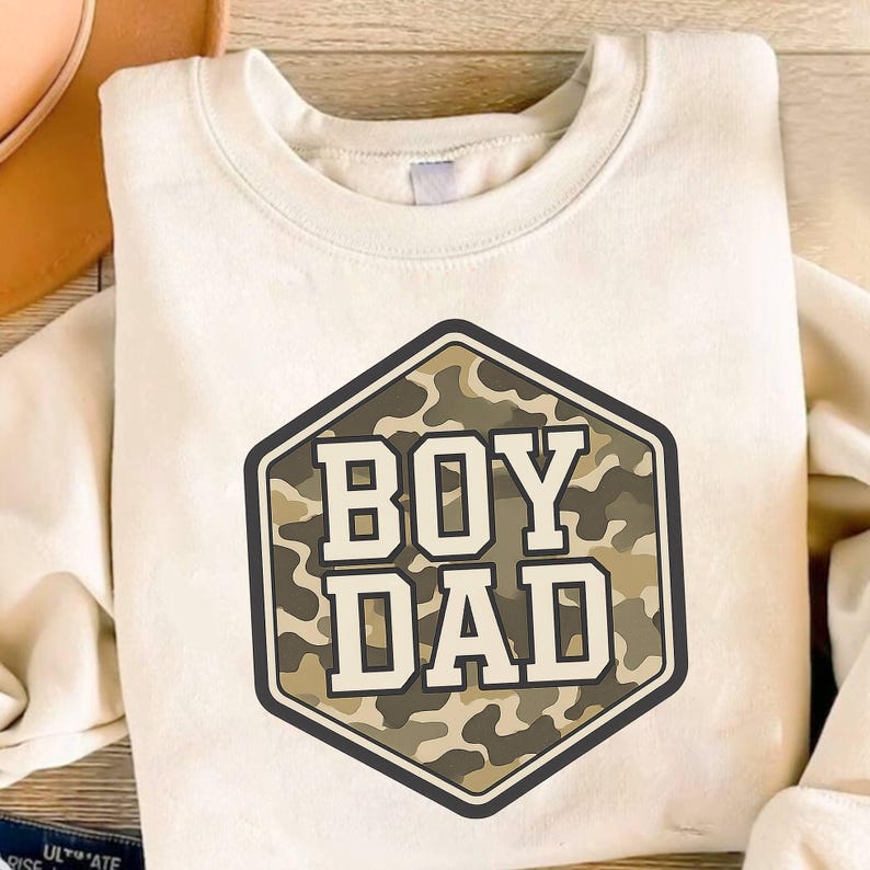 a t - shirt with the words boy dad printed on it