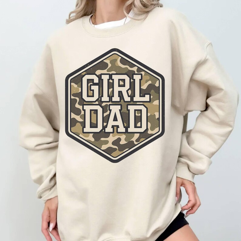 a woman wearing a sweatshirt that says girl dad
