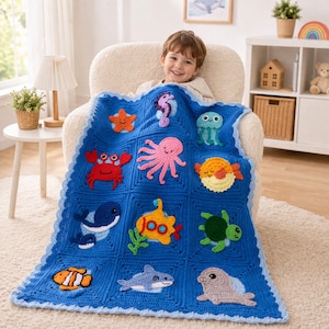 May include: A blue crochet blanket featuring various sea creatures, including a starfish, seahorse, octopus, crab, whale, and more. The blanket has a scalloped edge and is designed with a square pattern. The sea creatures are in bright colors.