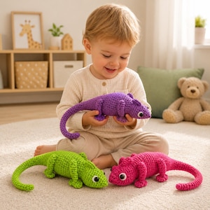 May include: A child holds a purple crocheted lizard toy, with two more in green and pink nearby. The handmade toys have white eyes and long tails. The toys are on a light-colored rug.
