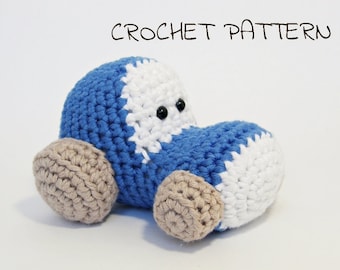 May include: A crocheted blue and white car with brown wheels. The car has black eyes and a smiling mouth.