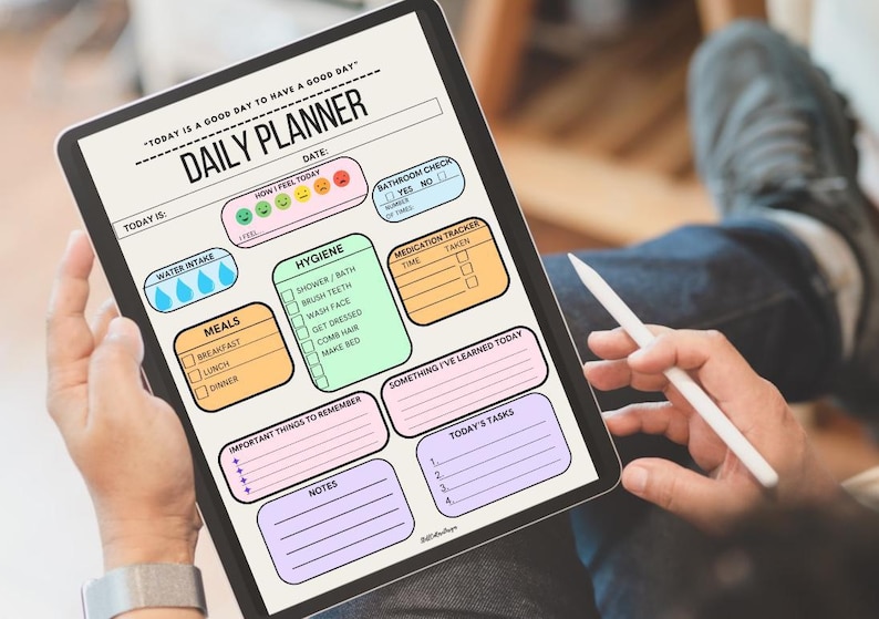 A daily planner printable with a light pink background. The planner has sections for water intake, meals, hygiene, bathroom check, medication tracker, important things to remember, notes, today's tasks, and something I've learned today. The planner also has a section for how you feel today with five emojis representing different emotions. The planner is on a tablet or iPad to use.
