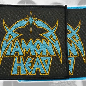 May include: Two square embroidered patches featuring the text DIAMOND HEAD in light blue lettering with a gold glitter outline. The design includes a stylized star above the text, all set against a black fabric background with a black border.