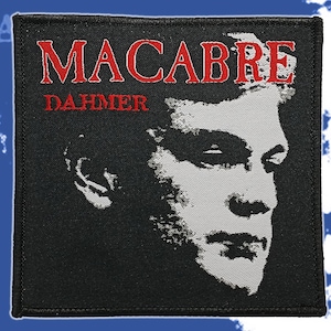 May include: Black square patch with a grayscale image of a man's face. The word "MACABRE" is embroidered in red above the word "DAHMER" in red. The patch has a black border.