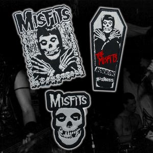 May include: Black and white patches featuring the band Misfits. The patches include the band's logo, a skull, and the words "Horror" and "Misfits". The patches are embroidered and have a black background.