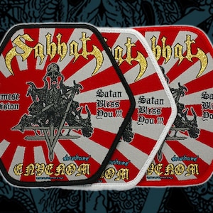 May include: Three hexagonal patches with a red and white sunburst design. The patches feature gold text that reads "Sabbat" and "ENHENOM OM". A black and white illustration of a demonic figure is in the center, with the text "Satan Bless Dou!!!".
