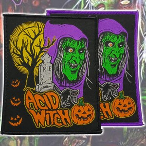 May include: Two rectangular black fabric patches featuring a green-skinned witch in a purple hood, a yellow full moon, a tombstone marked RIP, a black cat, three small orange jack-o'-lanterns, and the text ACID WITCH in orange lettering.