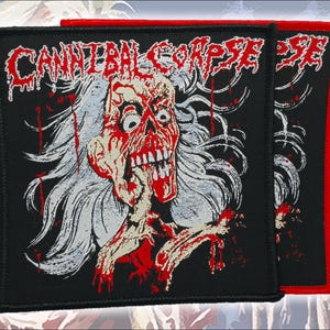 May include: Two square black fabric patches featuring the white text Cannibal Corpse at the top. The design displays a detailed illustration of a pale, skeletal figure with long hair, red blood accents, and a distressed expression on a black background.