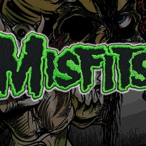 May include: Embroidered patch with the word "MISFITS" in black with a dripping green outline. The patch is set against a background of a monster illustration.