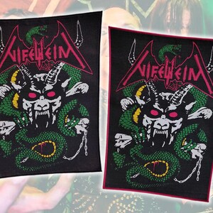 May include: Two rectangular black fabric patches featuring the Nifelheim logo in pink text at the top. Below the text is a graphic of a horned creature with glowing pink eyes, surrounded by a green snake and a silver chain on a black background.