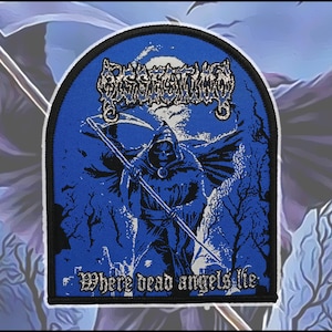 May include: A blue and black embroidered patch featuring a hooded grim reaper figure holding a scythe. The text Dissection is printed at the top in a stylized font, and the text Where dead angels lie is printed at the bottom in white.