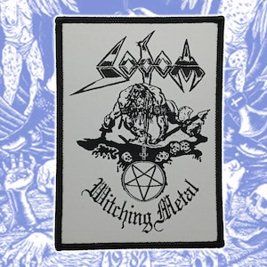 May include: A rectangular fabric patch with a black border on a white background. It features a black graphic illustration of a figure with an axe, a pentagram symbol, and the text Sodom and Witching Metal printed in black ink.