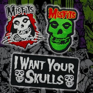May include: Embroidered patches featuring the Misfits band logo and skull imagery. One patch has a red and white skull, another a green skull, and a third reads "I Want Your Skulls" with skull graphics. The patches are black, white, red, and green.