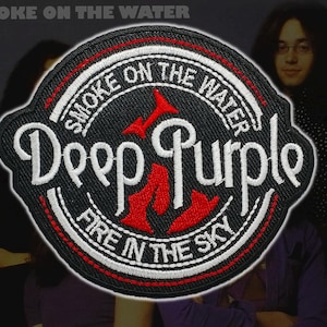 May include: Embroidered patch with the Deep Purple logo, the text "Smoke on the Water" and "Fire in the Sky". The patch is black with white and red detailing. The band's name is in a distinctive font.