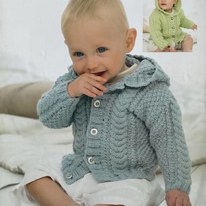 May include: A baby wearing a light blue knitted hooded cardigan with three white buttons. The cardigan has a cable knit design. The image also shows a smaller image of a baby wearing a green hooded cardigan. The text "SUPERSOFT ARAN" and "1759 Birth to 7 years" are visible.