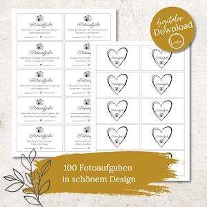 Puede incluir: Una descarga digital con tarjetas de desafío fotográfico con un icono de cámara y diseños de corazón. Las tarjetas tienen texto en alemán, incluyendo "Fotoaufgabe" y "100 Fotoaufgaben in schönem Design."