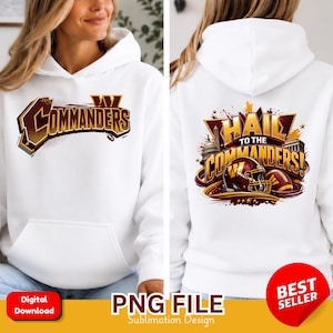 May include: A white hooded sweatshirt featuring a graphic on the front with the text Commanders in burgundy and gold. The back graphic displays the text Hail to the Commanders with a football helmet, a football, and architectural silhouettes.