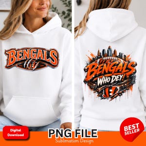 Könnte beinhalten: Ein weißer Kapuzenpullover mit einer Vorderseite, die den orange-schwarzen Schriftzug BENGALS und ein Krallenmuster zeigt. Die Rückseite zeigt eine Skyline, einen Football, den Schriftzug BENGALS WHO DEY und ein Tigerstreifen-Logo.