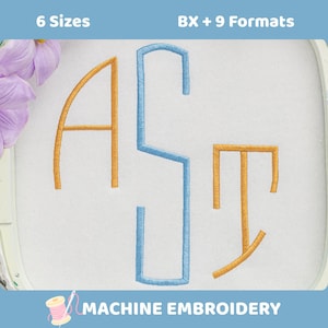 May include: An embroidery design featuring the letters A, S, and T stitched in gold and blue thread on white fabric. The text 6 Sizes and BX + 9 Formats appears at the top, with the text MACHINE EMBROIDERY and a spool icon at the bottom.