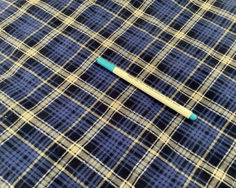 May include: A blue and white plaid fabric with a pen. The pen is white with a blue tip and text that reads "Please take in a cap with hands not with a mouth."