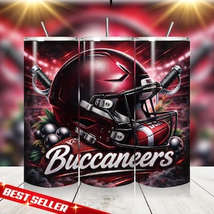 May include: A set of three stainless steel tumblers with a football theme. Each tumbler features a maroon football helmet, a football, and the word "Buccaneers" in white. The design includes a stadium background and decorative elements.
