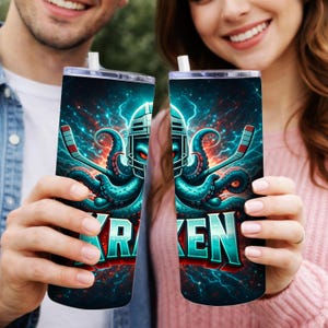 May include: Two stainless steel tumblers with a vibrant design featuring an octopus wearing a hockey helmet and holding a hockey stick. The word "KRAKEN" is displayed in bold letters. The background is a dynamic blend of blue and red lightning.