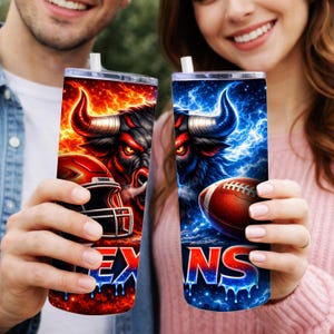 May include: Two stainless steel tumblers with lids and straws. One features a red and orange bull with a football helmet, the other a blue bull with a football. The word "EX" is visible on one, and "NS" on the other.