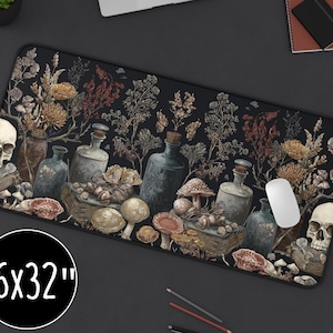 May include: Black rectangular desk mat with a botanical and skull design. The mat features illustrations of mushrooms, bottles, flowers, and skulls. The mat measures 16 x 32 inches.