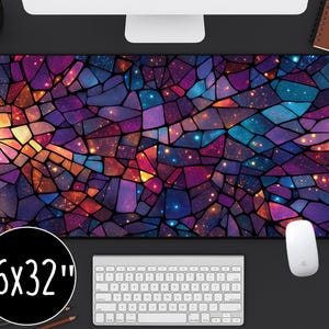 May include: A large rectangular mouse pad with a stained glass design in shades of purple, blue, orange, and yellow. The mouse pad measures 16 x 32 inches and has a black border. A white mouse and keyboard are visible.