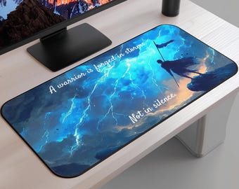 May include: Rectangular mouse mat featuring a dramatic illustration of a warrior figure against a stormy sky with lightning. The mat has the text "A warrior is forged in storms. Not in silence."