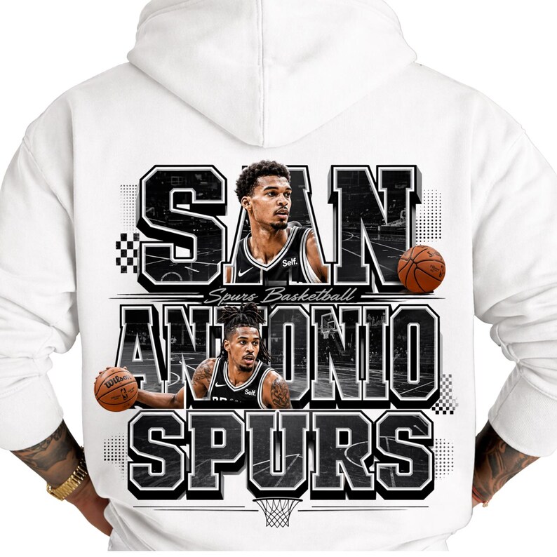 May include: White hoodie featuring a graphic design for the San Antonio Spurs basketball team. The design includes the team name, player images, and basketballs. The text "SAN ANTONIO SPURS" is prominently displayed.
