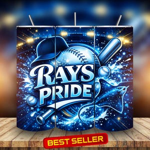 May include: A set of three stainless steel tumblers with a baseball-themed design. The design features the words "Rays Pride" in white and blue, along with baseballs, a baseball bat, and a baseball cap. The background is a dark blue with a stadium and light effects.