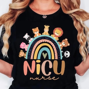 May include: Black t-shirt featuring a colorful rainbow design with cartoon animals, including a zebra, tiger, giraffe, lion, bear, panda, and monkey. The text "NICU nurse" is displayed below the rainbow in a playful font.