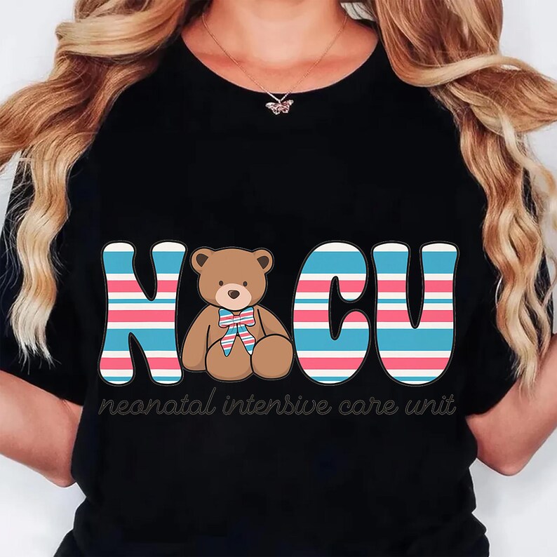 May include: Black t-shirt with the letters "NICU" in blue and pink stripes, featuring a brown teddy bear with a bow tie. The words "neonatal intensive care unit" are printed below the letters.