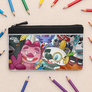 May include: Black zippered pencil case featuring a colorful cartoon design with the text "The Randle Bots." The case is surrounded by various colored pencils.