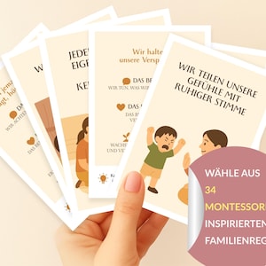 May include: A hand holds a fan of cards with illustrations and German text. The cards show images of people and phrases such as "Wir teilen unsere Gefühle mit ruhiger Stimme." A sticker reads "WÄHLE AUS 34 MONTESSORI-INSPIRIERTEN FAMILIENREGELN."