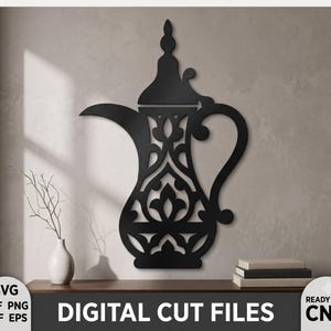 May include: A black wall-mounted metal art piece shaped like a traditional dallah coffee pot with intricate cut-out floral and geometric patterns. The design features a long curved spout, a tall pointed lid, and a handle, presented as digital cut files.