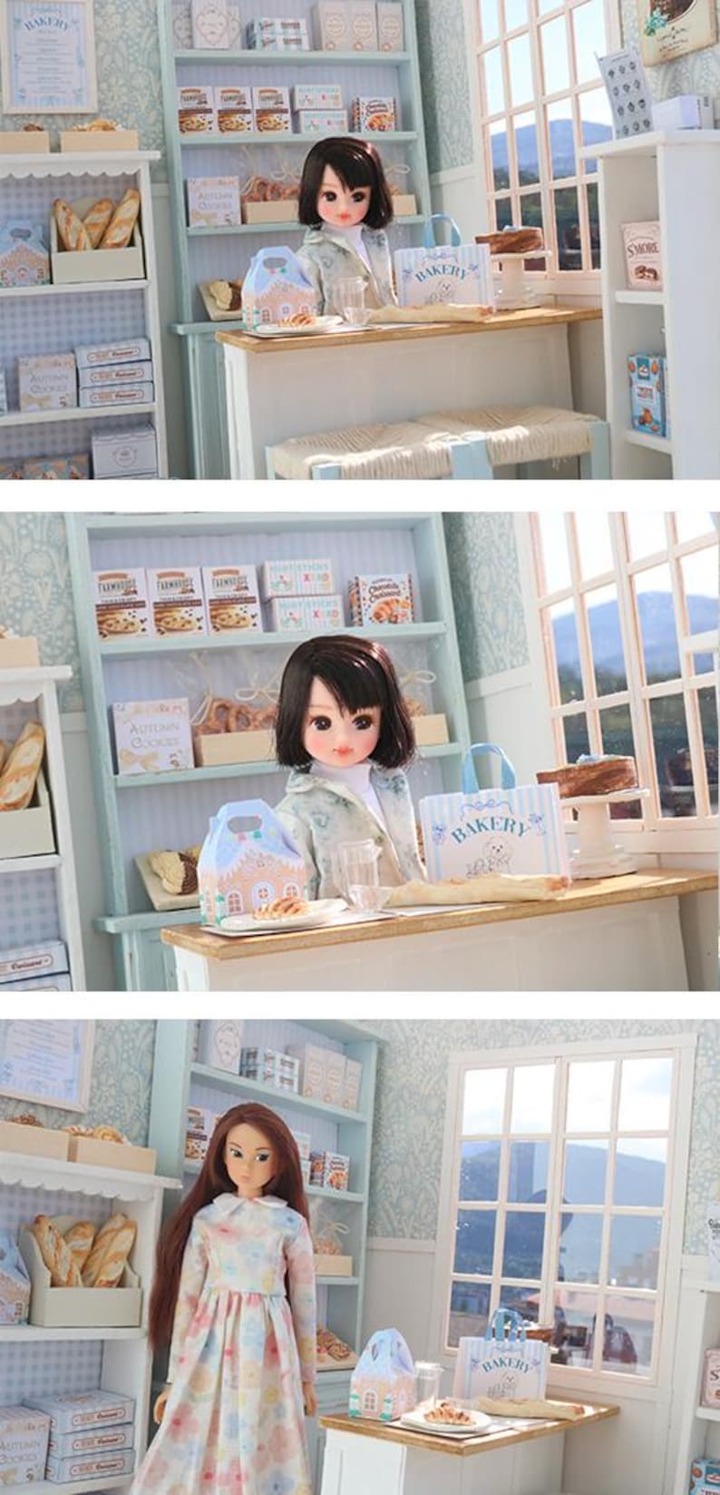 May include: A miniature bakery scene featuring a doll with dark hair, a light-colored jacket, and a white top. The bakery includes shelves stocked with boxes of cookies, bread, and pastries, a wooden counter, and a blue-and-white striped bakery bag.