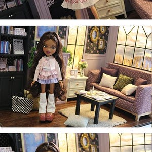 May include: A doll with long brown hair wearing a light pink cardigan, a layered pink and lavender ruffled skirt, and white leg warmers with pink polka dots. The doll has brown eyes, dark lipstick, and is standing in a miniature living room setting.