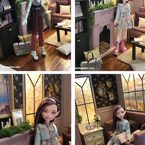 May include: A doll with long dark hair featuring pink highlights, wearing a light blue cardigan over a floral dress, white patterned tights, and pink platform boots. The doll is posed in a miniature room setting with a fireplace and furniture.