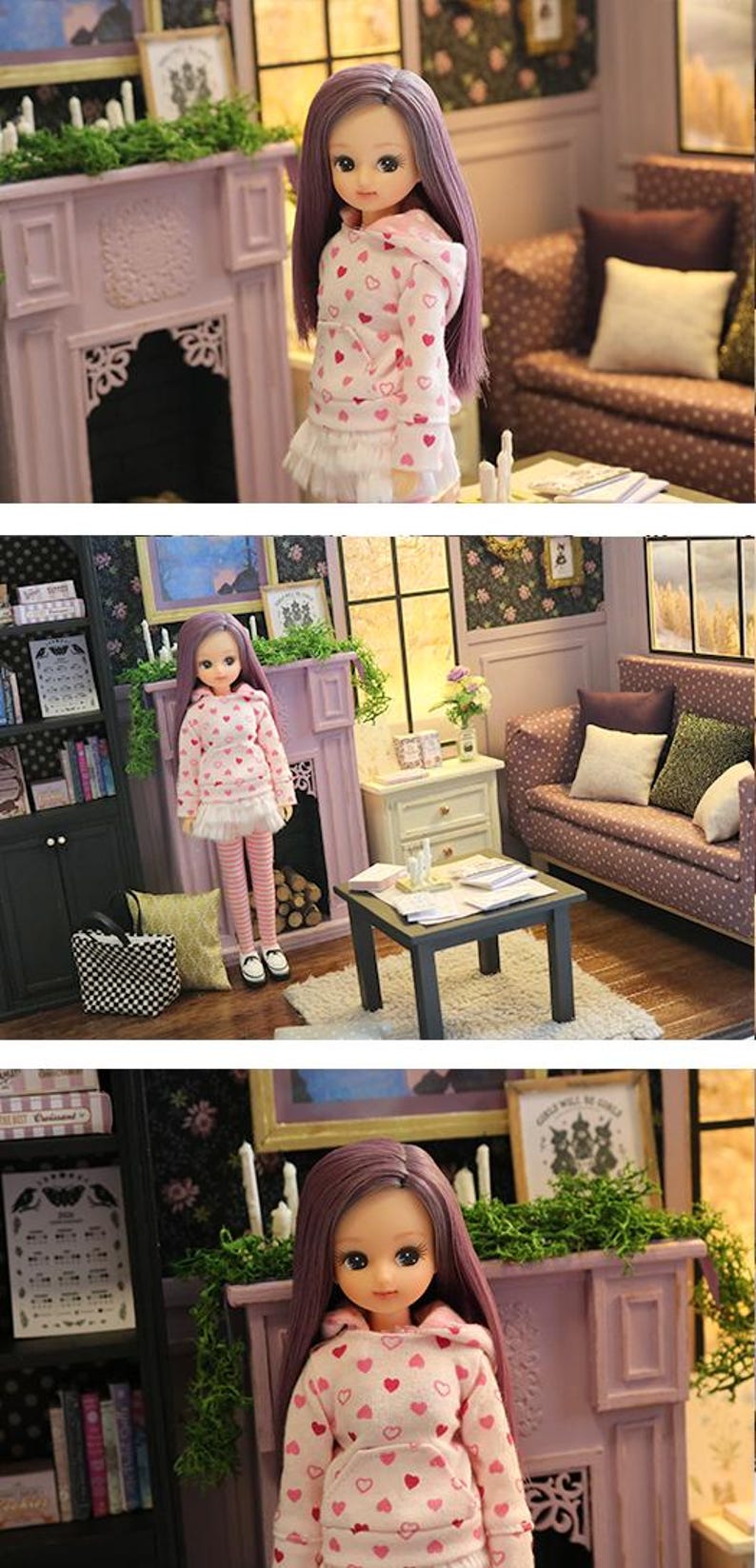 May include: A doll with long purple hair wearing a white hooded sweatshirt featuring a pink heart pattern, a white pleated skirt, and pink and white striped leggings. The doll has large brown eyes and is standing in a miniature room setting.