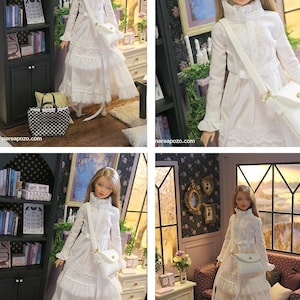 May include: A blonde doll wearing a long-sleeved white dress with a ruffled collar, lace detailing, and a tiered skirt. The doll carries a white crossbody bag with a gold clasp. The text "nereapozo.com" is visible in the bottom corners.