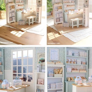 May include: A miniature bakery diorama featuring light blue and white shelving units, a wooden counter, two stools with woven seats, and various small boxes and bags labeled with bakery-themed text. The scene includes a window and wall decor.